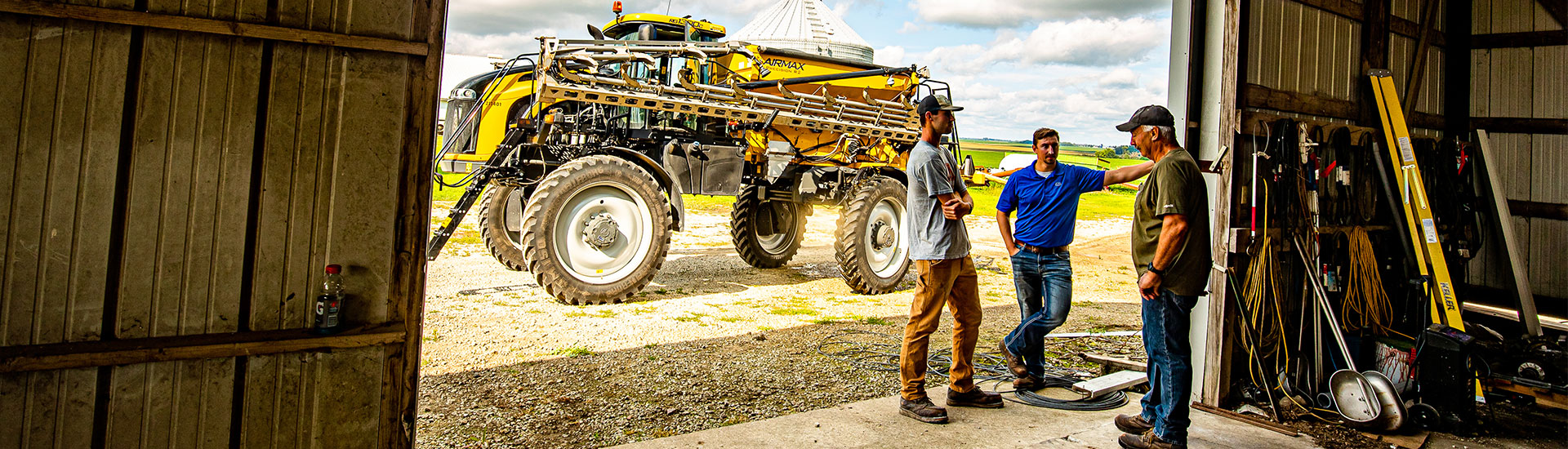 Men talking in a farm building