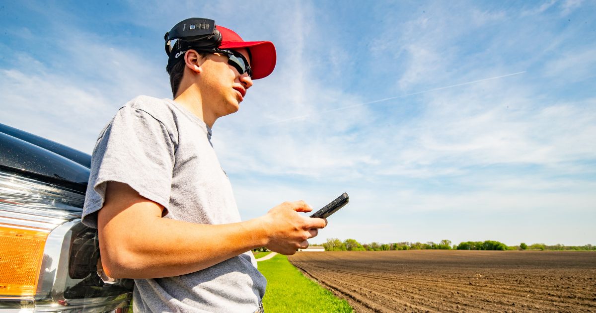 Man holding a phone in a field